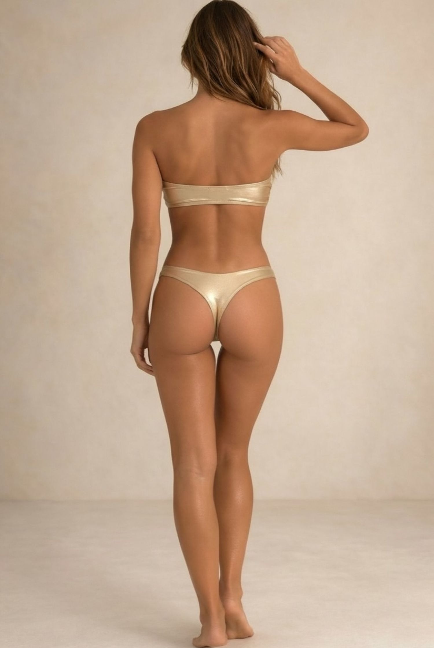 Back view of the Lumière light gold metallic bikini with thong coverage by Nora Chantre.