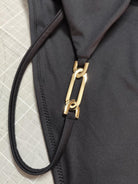 Aurelia Black swimsuit detail with statement gold chain hardware, handmade in Mallorca by Nora Chantre.