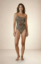 Leopard print one-shoulder swimsuit with gold hardware, front studio view, Nora Chantre Swimwear