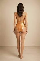 Back view of the Lumière copper metallic swimsuit by Nora Chantre.