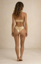 Back view of the Lumière light gold metallic bikini with Brazilian coverage by Nora Chantre.