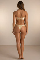 Back view of the Lumière light gold metallic bikini with ruched bottom by Nora Chantre.